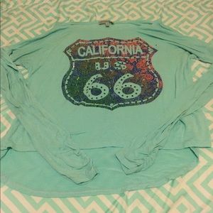 A mint green, dark blue, & pink shirt.